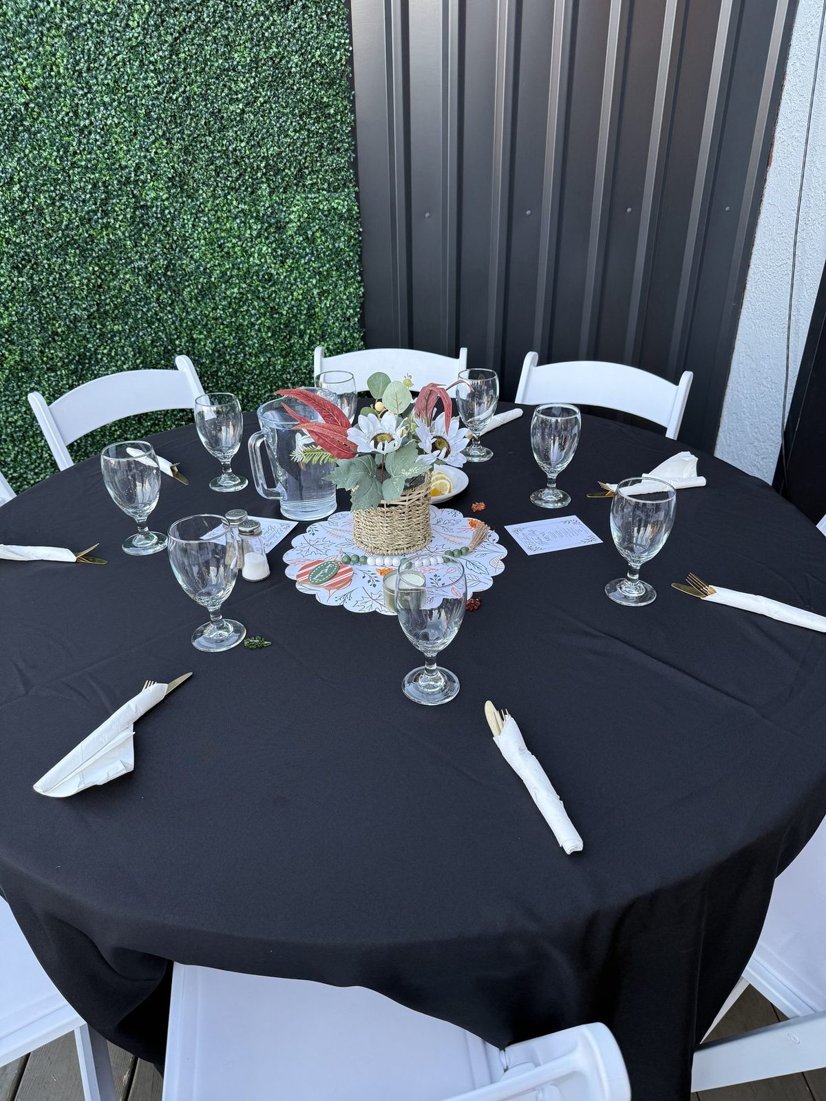 Round table set with glasses and flowers