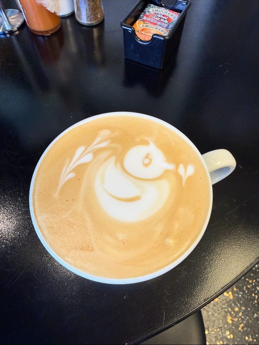 Latte with latte art on a dark table