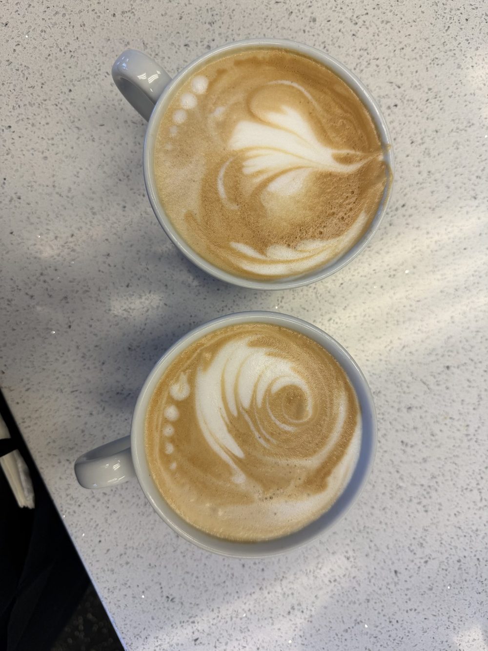 Two lattes with latte art