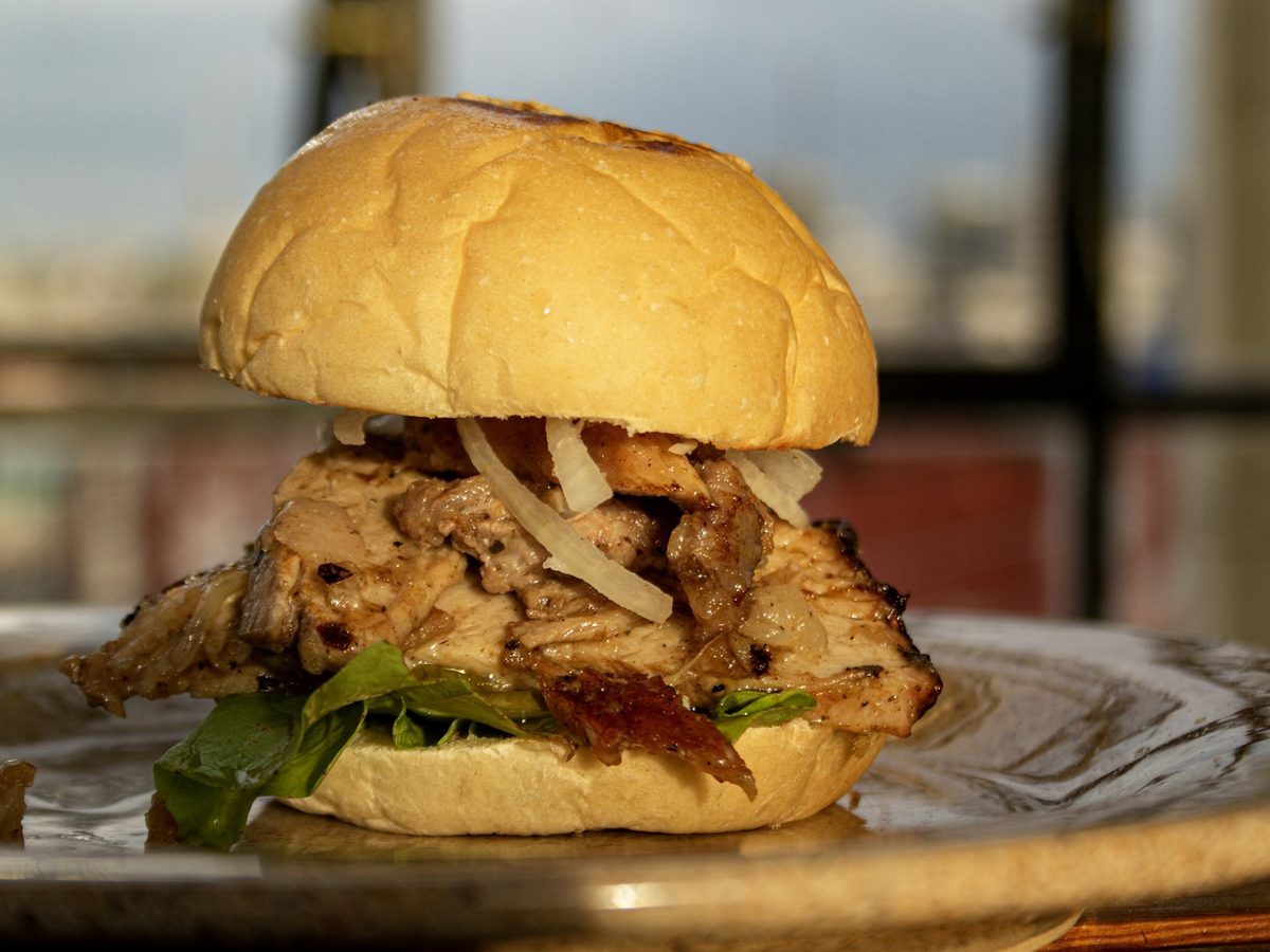 Pulled pork sandwich on a toasted bun — illustrative