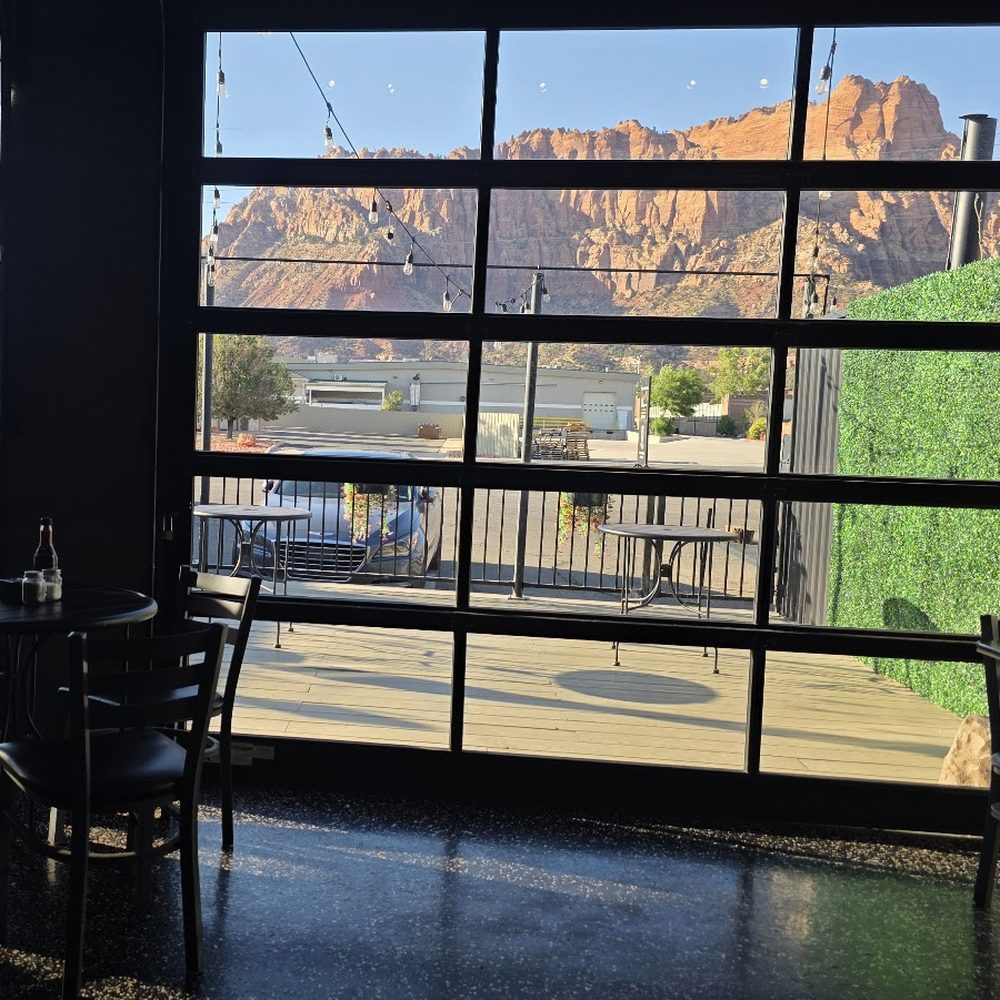 Inside El Cappuccino by the glass garage doors, with the patio outside