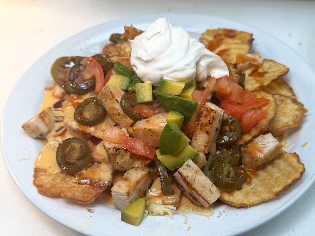 El Cappuccino’s nachos piled with grilled chicken, cheese sauce, jalapeños, tomato, avocado and sour cream